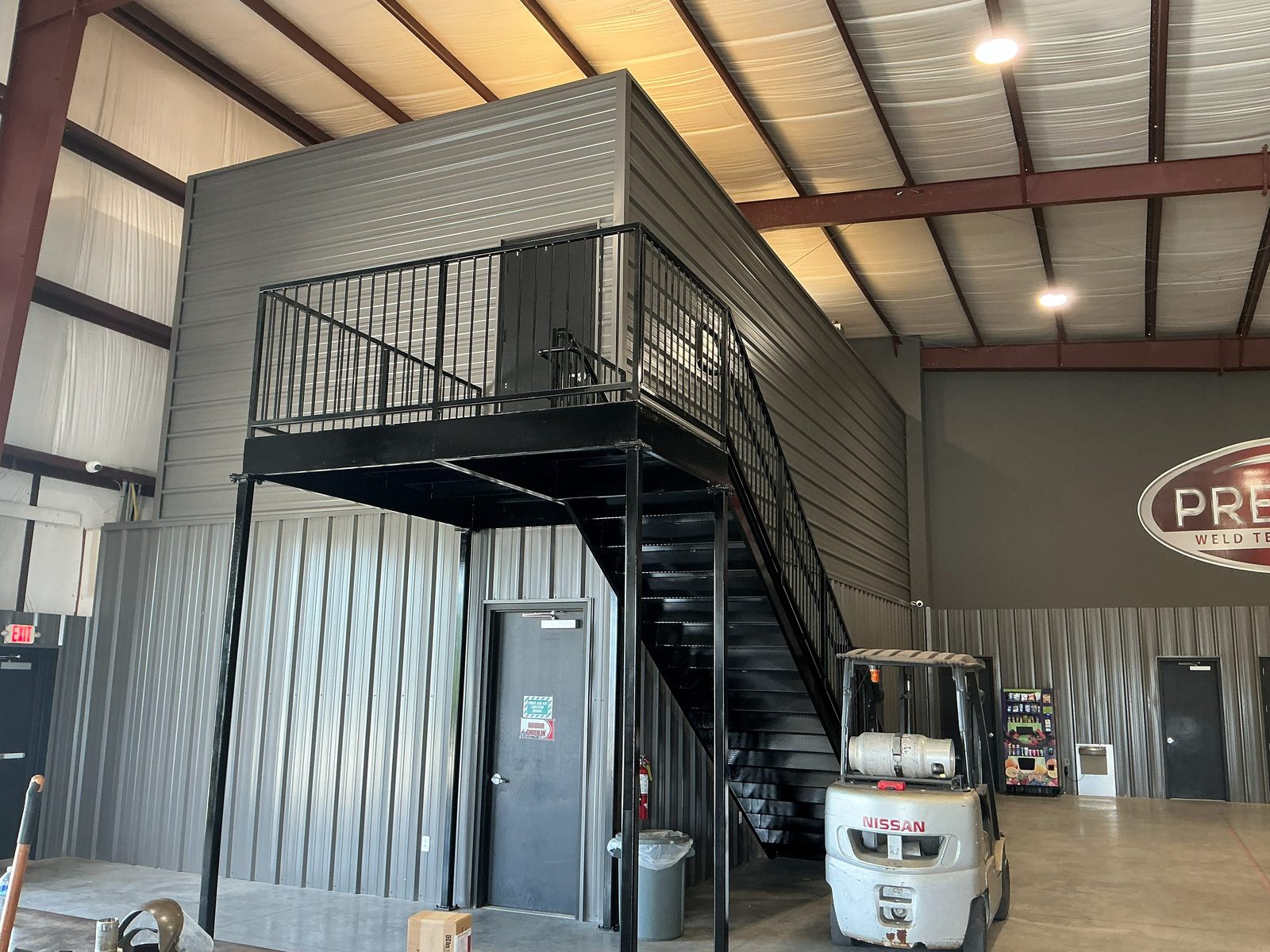 New steel mezzanine and stair inside the existing metal building