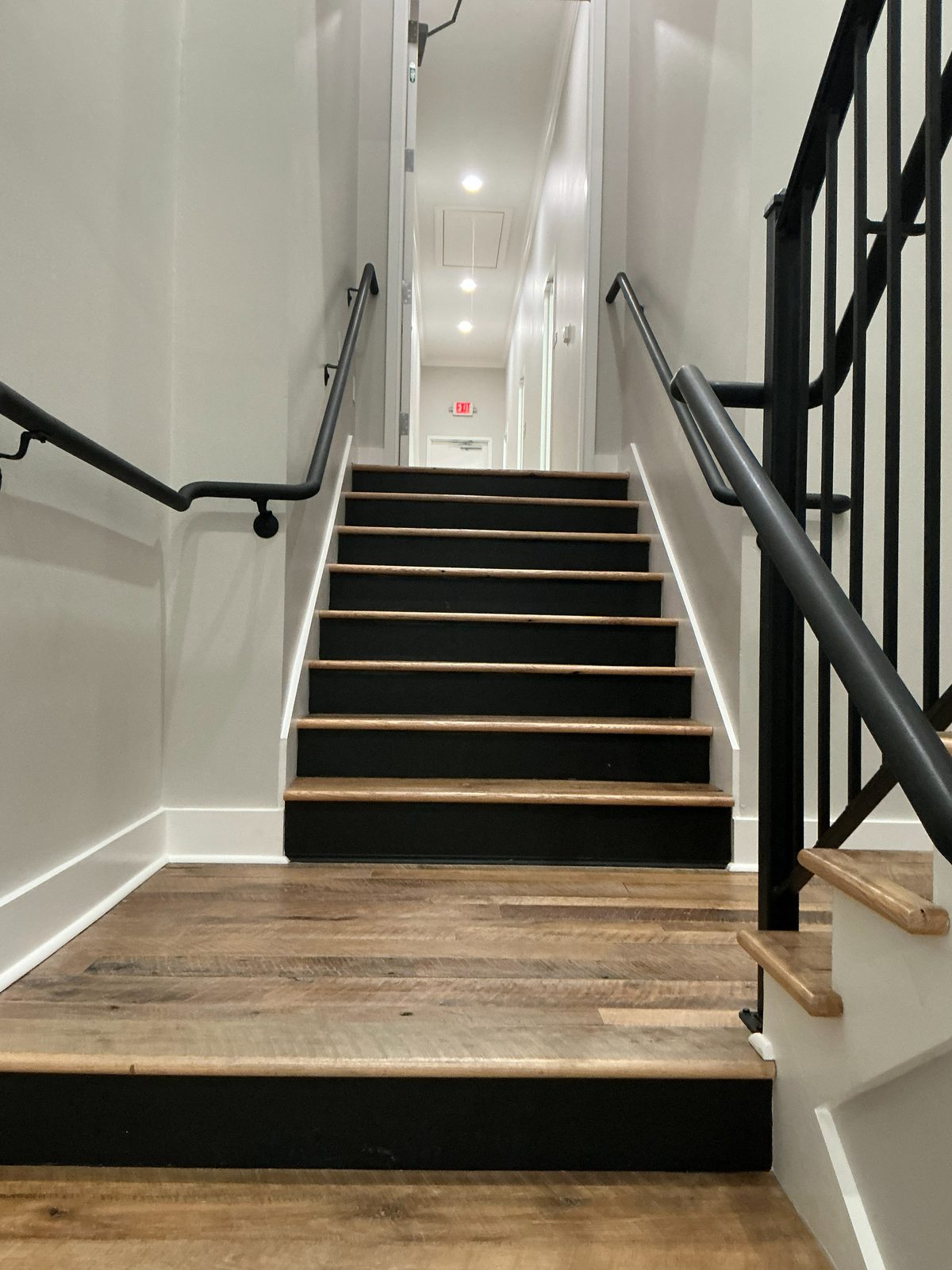 Finished stair with wood treads and steel railing