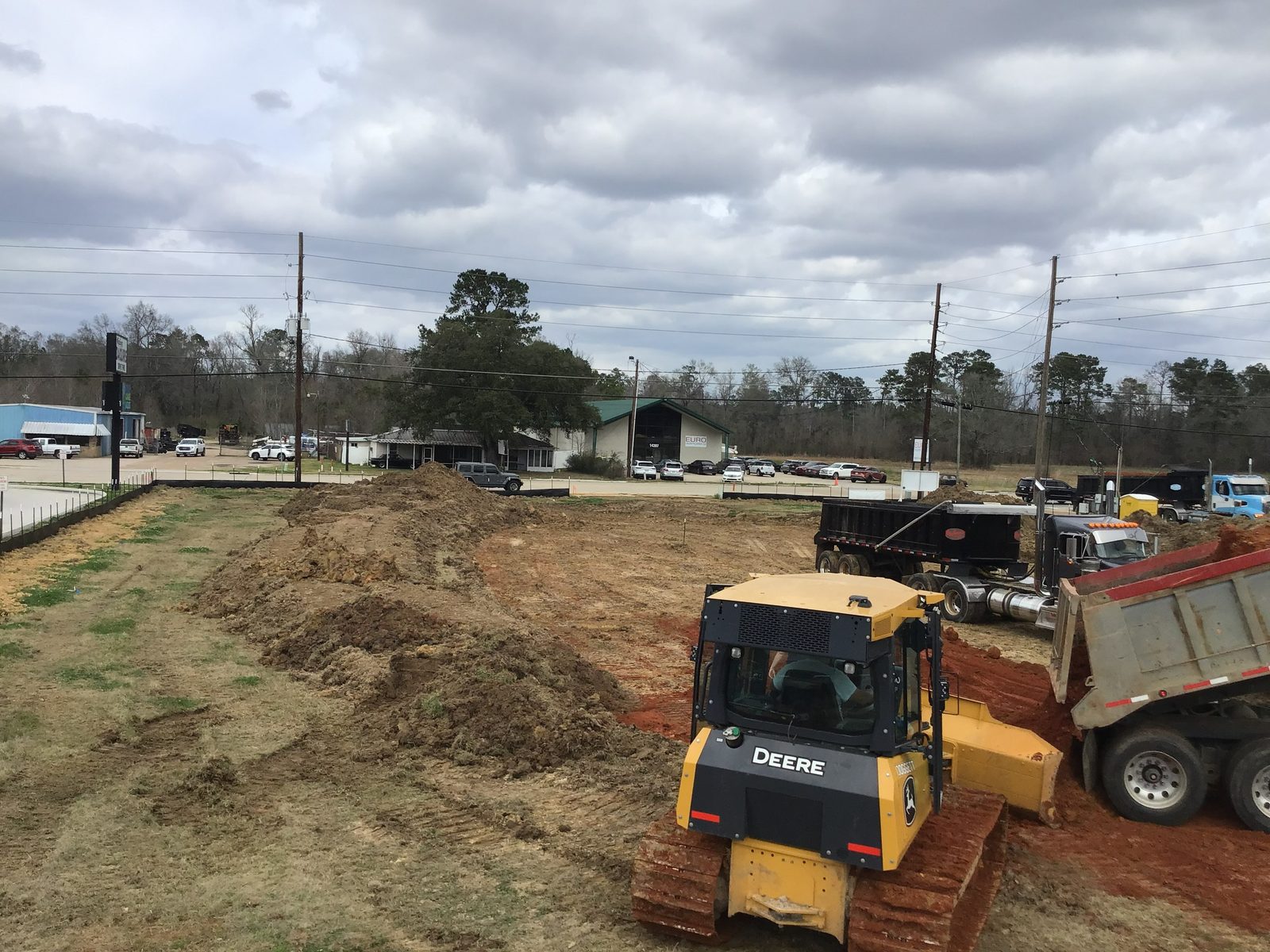 Site clearing with a dozer and dump truck before construction began