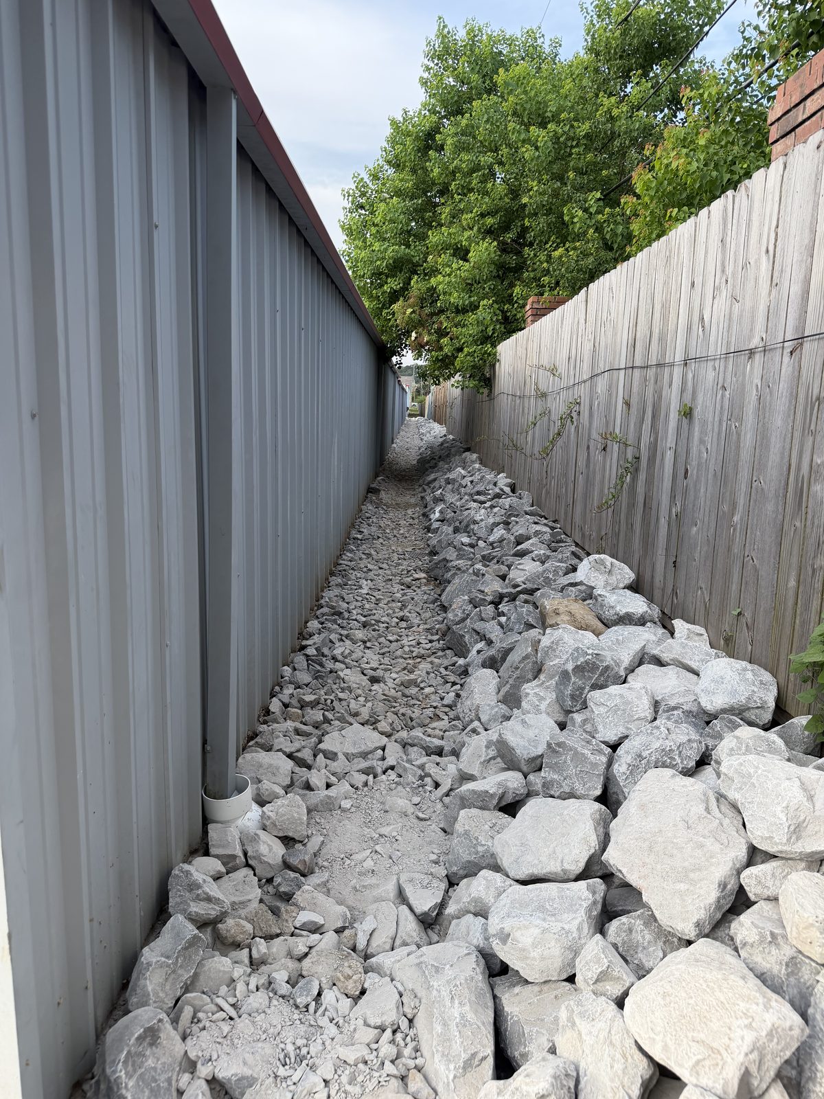 Graded riprap armoring the channel along the fence line
