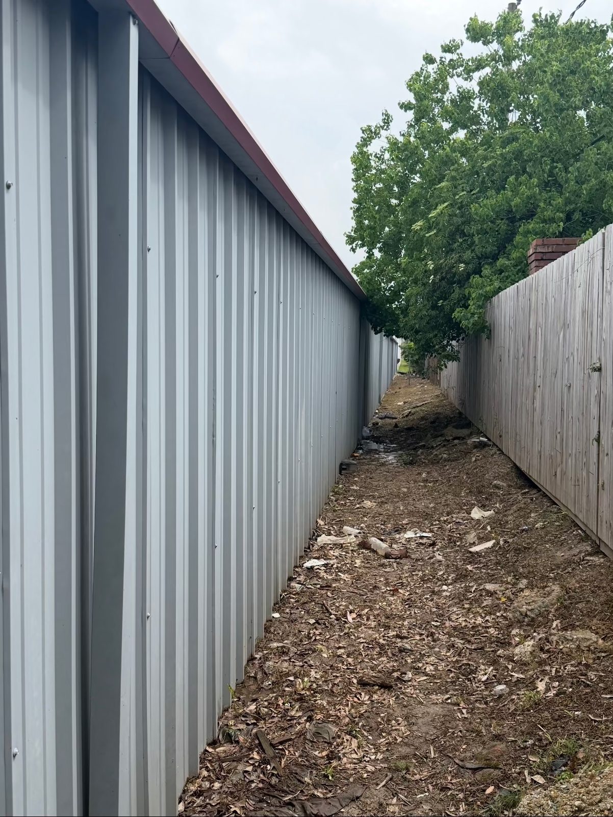 Narrow alley before the work, holding debris and washed-in soil